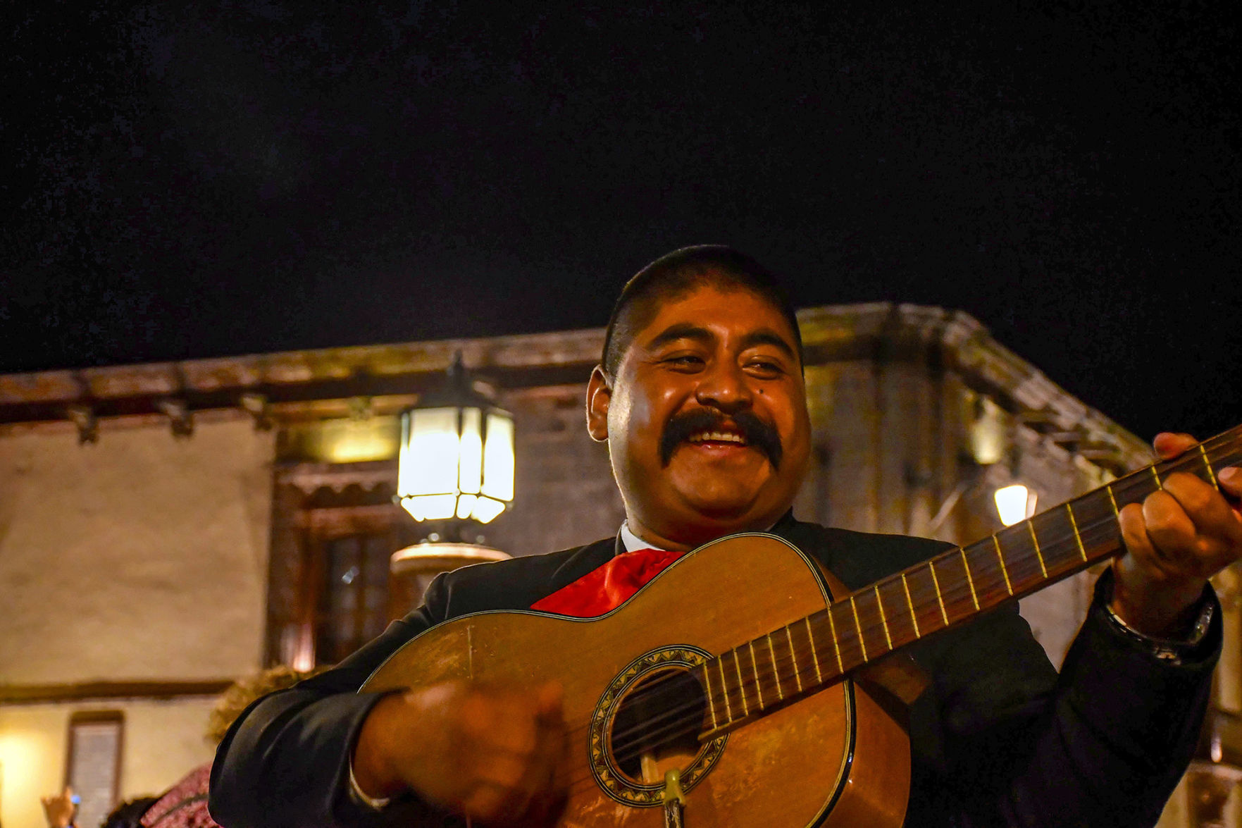 I started watching a guitarist who wore a frown worthy of a 19th century executioner. I snapped a shot. Then came a grin and laughter. More emotion -- even better.